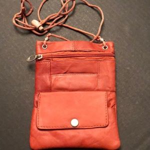 Small crossbody golden brown bag with change pocket and phone pocket.